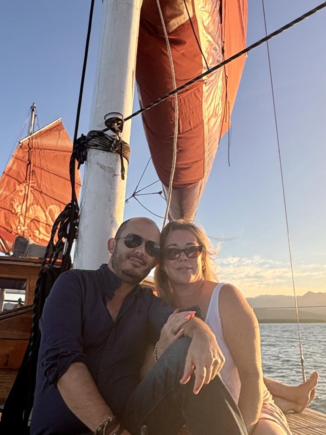 Gabriel Machuret and Kristy sailing together at sunset